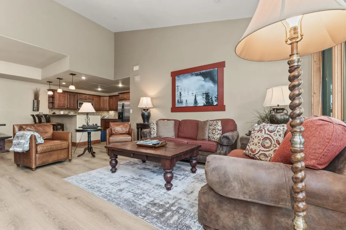 A comfortable seating area with a coffee table, artwork, and ample light—an inviting spot for relaxing with friends, reading, or planning the day's adventures.